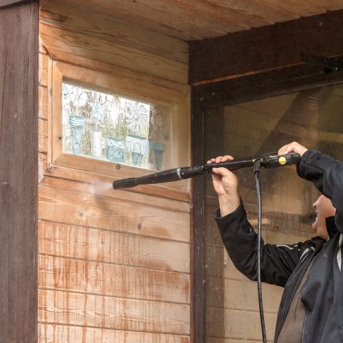 Man Cleaning Walls With Pressure Washer Union City